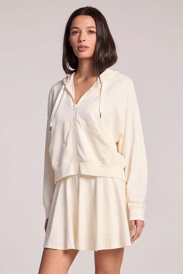 Front view of a woman wearing the Chaser Coconut Milk Abilena on a neutral background