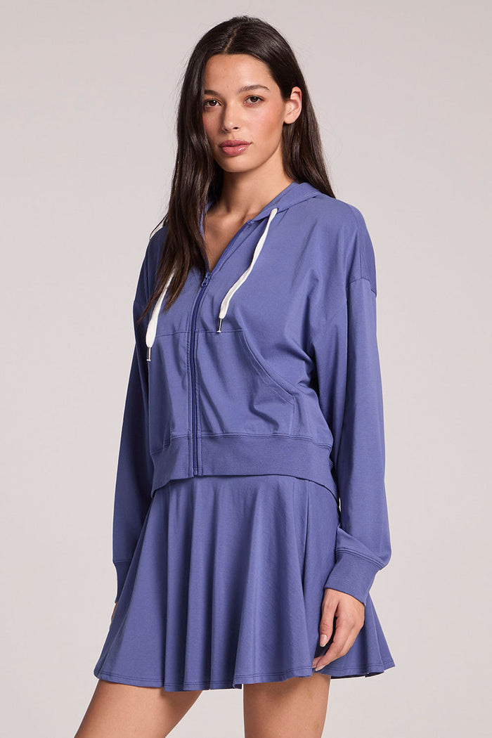 Front view of a woman wearing the Chaser French Riviera Abilena Zip-Up on a neutral background