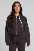 Front view of a woman wearing the Chaser  Abilene Dark Heather Grey Zip Up on a neutral background