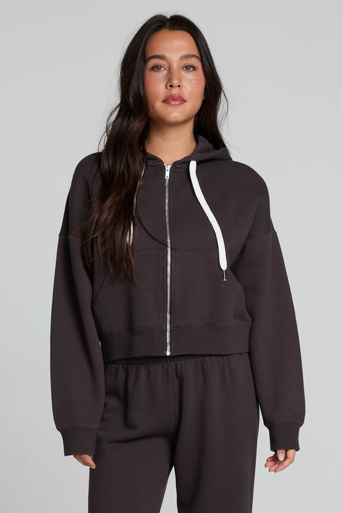 Front view of a woman wearing the Chaser  Abilene Dark Heather Grey Zip Up on a neutral background