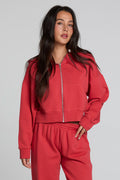 Front view of a woman wearing the Chaser  Abilene Dry Red Zip Upon a neutral background