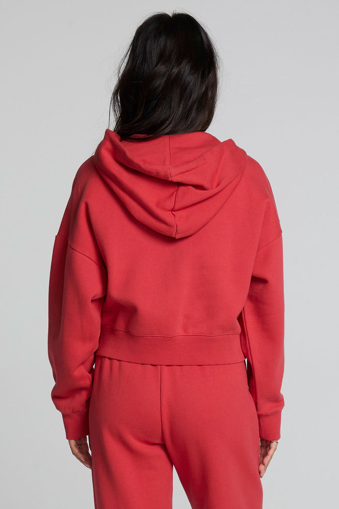 Back view of a woman wearing the Chaser  Abilene Dry Red Zip Up on a neutral background with matching pants