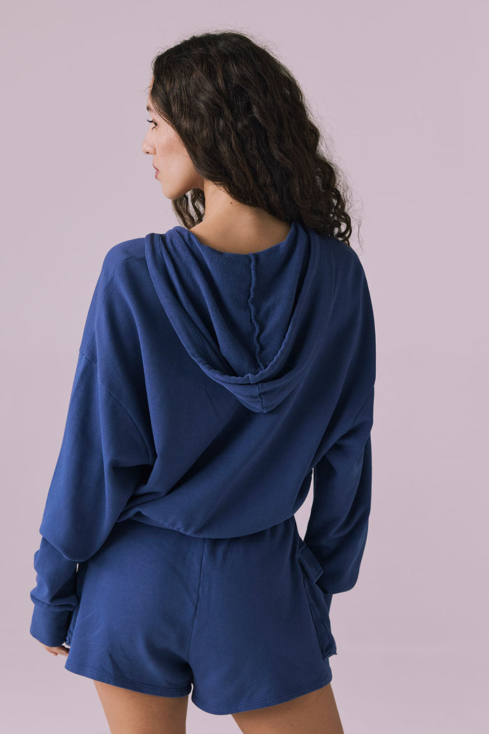 Back view of the Chaser Abilene Honest Indigo Zip Up Hoodie highlighting the attached hood and smooth fleece texture