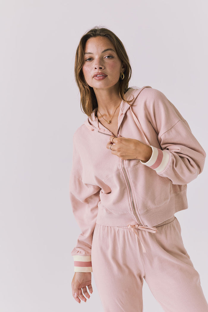 Close up of the Chaser Abilene Honey Peach Zip Up hoodie showing the zip front and striped cuff detailing