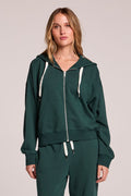 Front view of a woman wearing the Chaser  Abilene Pine Pullover and matching pants on a neutral background