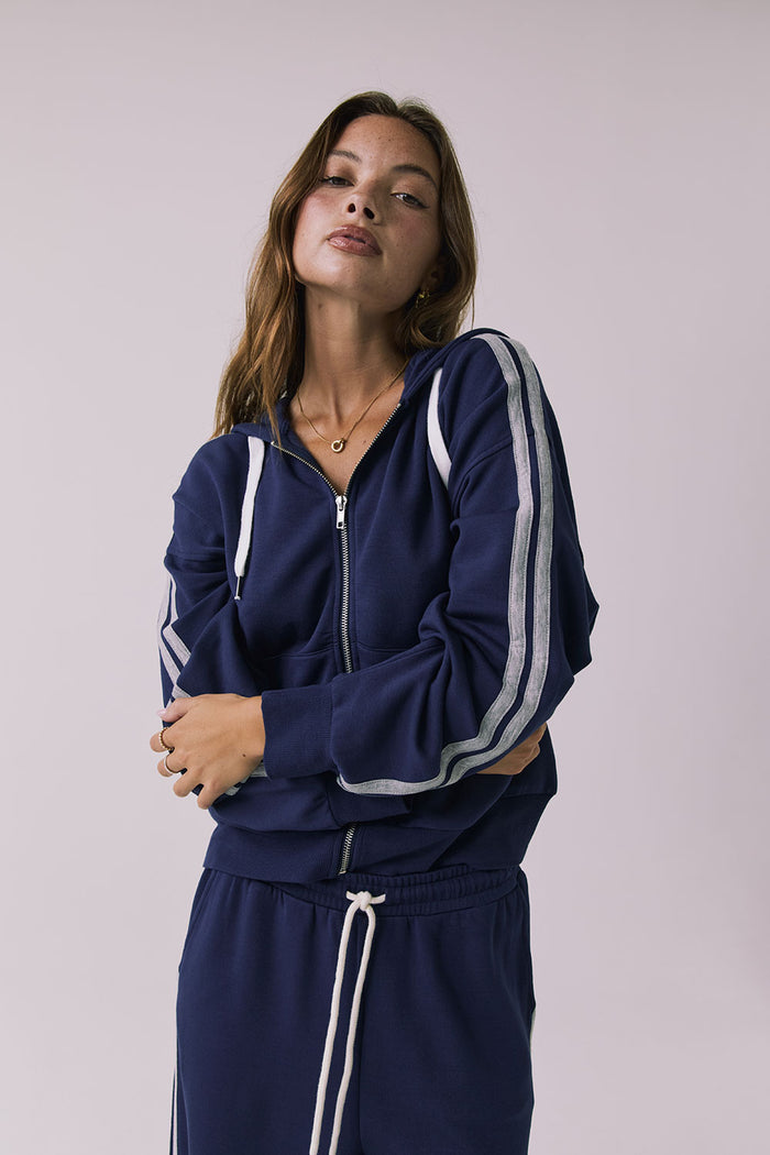 Close view of the Chaser Abilene Sapphire Zip Up focusing on the zipper and striped sleeves