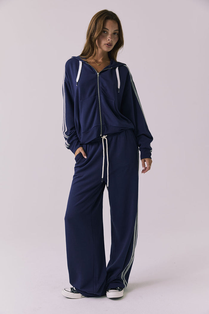 Chaser Abilene Sapphire Zip Up styled with matching Sandi Sapphire Joggers in a full body studio frame