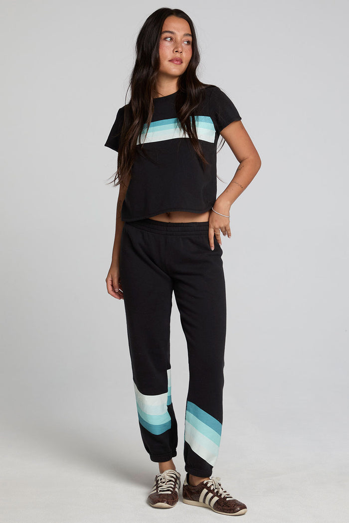 A full body front view of a woman wearing the Chaser Ada Black Jogger on a neutral background