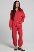 Full body front view of a woman wearing the Chaser Ada Dry Red Jogger on a neutral background