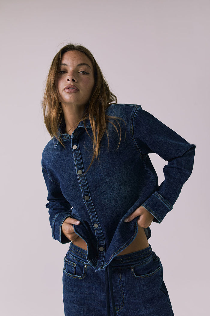 Chaser All Day Indigo Wash Button Down in Indigo Wash shown in a dynamic front angle emphasizing the easy fit and snap-front closure