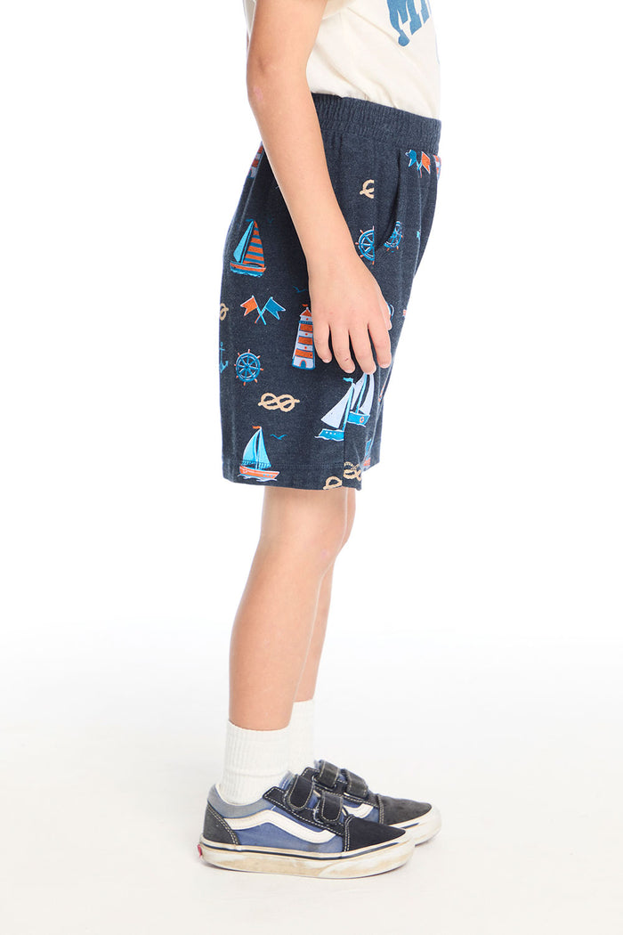 Side view of Chaser Kids Allover Sailboats Shorts showing the nautical allover pattern and elastic waistband detail