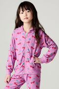 Front view of a girl wearing the Chaser Allover Sweethearts Girls Hoodie on a neutral background with matching pink pants