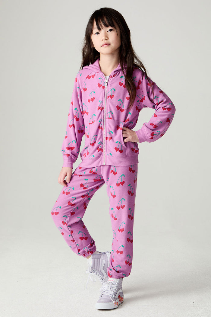 A full body front view of a girl wearing the Chaser Allover Sweethearts Girls Hoodie on a neutral background