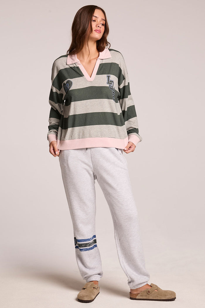 Full body front view of a woman wearing the Chaser Allstar 62  Long Sleeve and clogs on a neutral background