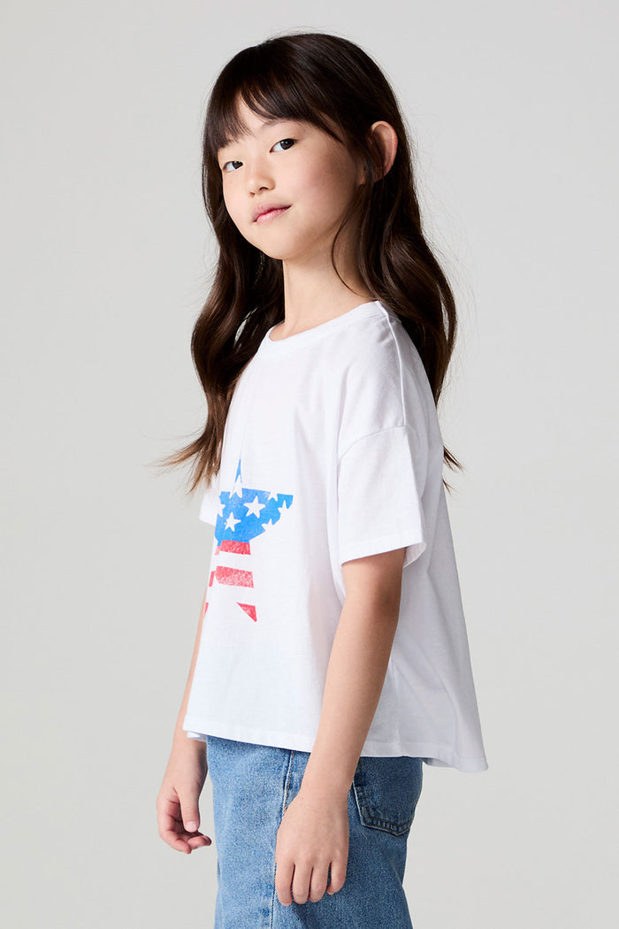 Side view of a girl wearing the Chaser  Americana Star Tee on a neutral background