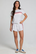 A full body front view of a woman wearing the Chaser Ana Light Heather Grey Shorts on a neutral background