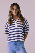 Woman wearing the Chaser Antoni Castaway Stripe Tee featuring wide navy and white stripes with a classic buttoned polo neckline