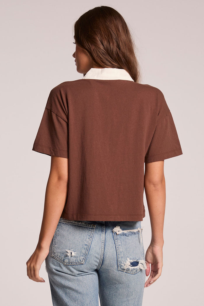 Back view of a woman wearing the Chaser Antoni Kahlua Tee on a neutral background