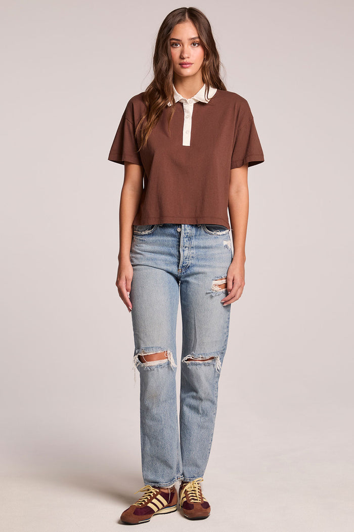 Front view of a woman wearing the Chaser Antoni Kahlua Tee and sneakers on a neutral background