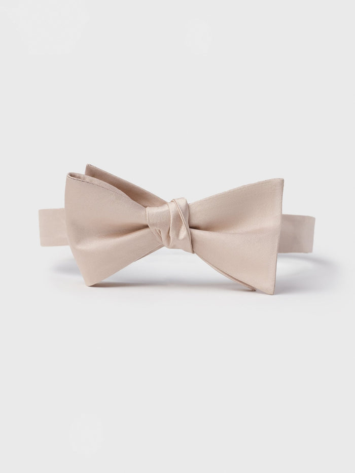Apricot satin butterfly bow tie, pre-tied, front view on a grey background.