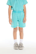 Front view of boy wearing the Chaser Kids Aqua Teal Cozy Beach Shorts with elastic waistband and soft terry texture, paired with the matching Aqua Teal Polo Shirt on a white background