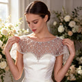 Art Deco crystal beaded bridal capelet with illusion tulle and faux pearl embroidery.