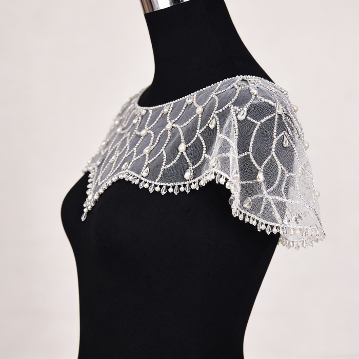 Art Deco crystal beaded bridal capelet with illusion tulle and faux pearl embroidery.