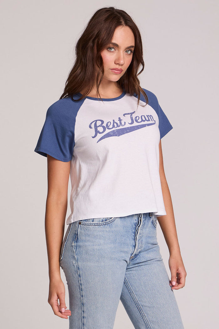 Front view of a woman wearing the Chaser Athletics Club Tee on a neutral background with blue jeans
