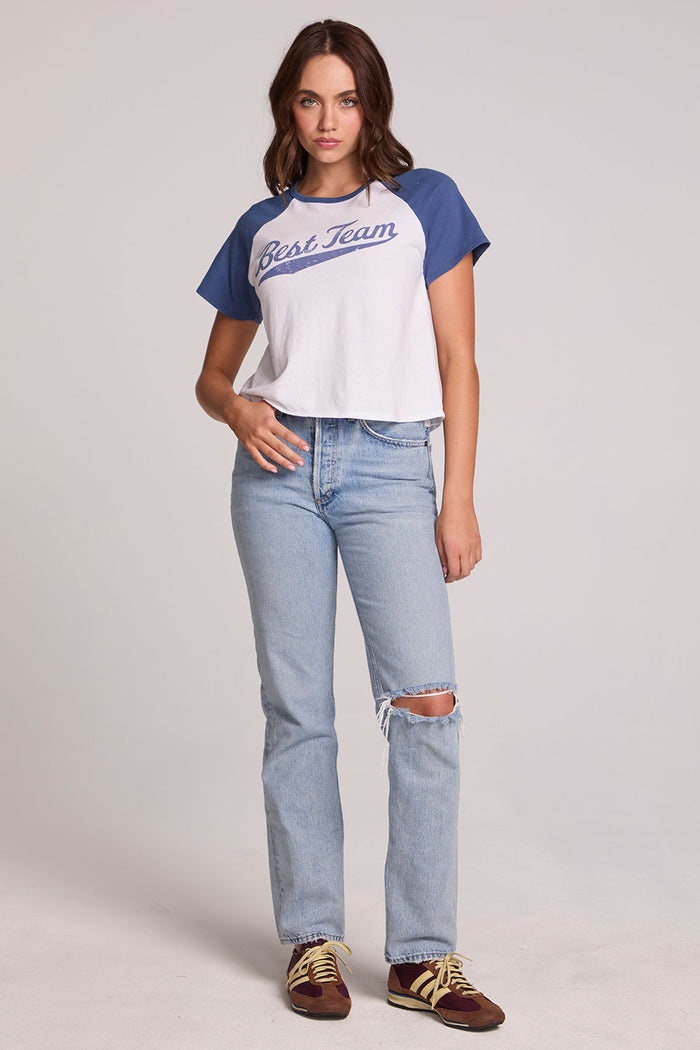 A full body front view of a woman wearing the Chaser Athletics Club Tee on a neutral background