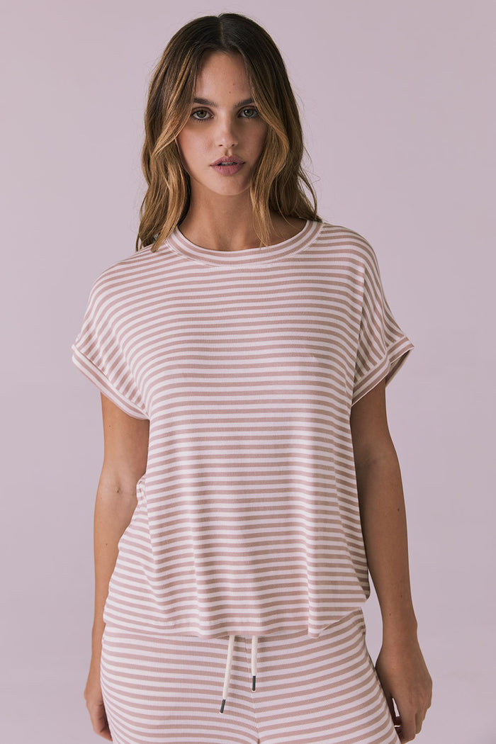 Woman wearing the Chaser Audrey Khaki Stripe Tee featuring narrow khaki and white horizontal stripes with rolled short sleeves