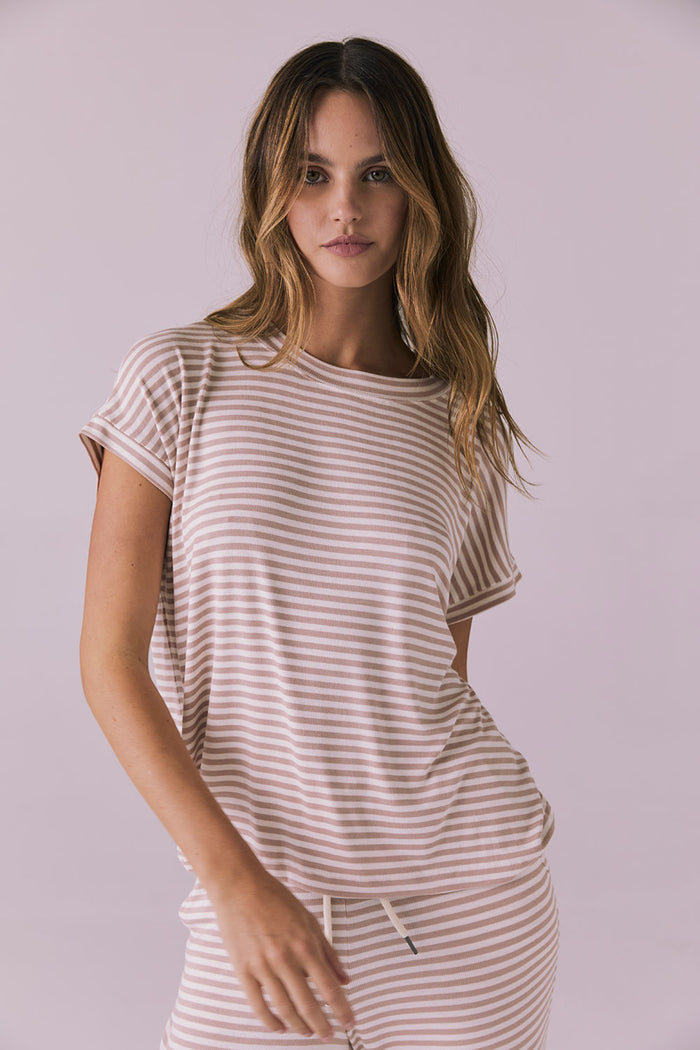Woman wearing the Chaser Audrey Khaki Stripe Tee featuring narrow khaki and white horizontal stripes with rolled short sleeves