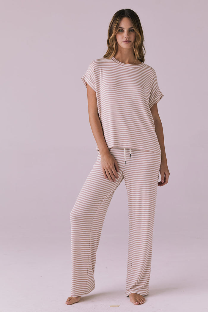 Woman wearing the Chaser Audrey Khaki Stripe Tee paired with the matching Sandyy Khaki Stripe Trouser in a relaxed lounge set