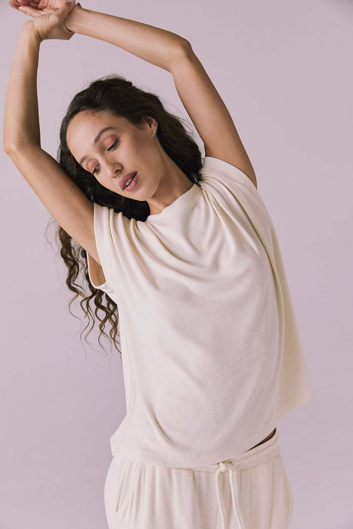 Woman wearing the Chaser Audrey Starry White Tee featuring a relaxed silhouette and rolled short sleeves in soft ribbed knit