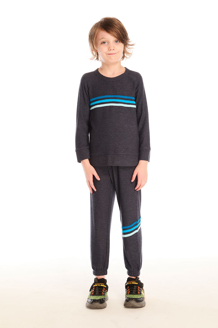 Full body view of boy wearing Chaser’s Avalon Lounge Pant with blue stripe strappings and matching top against a white background