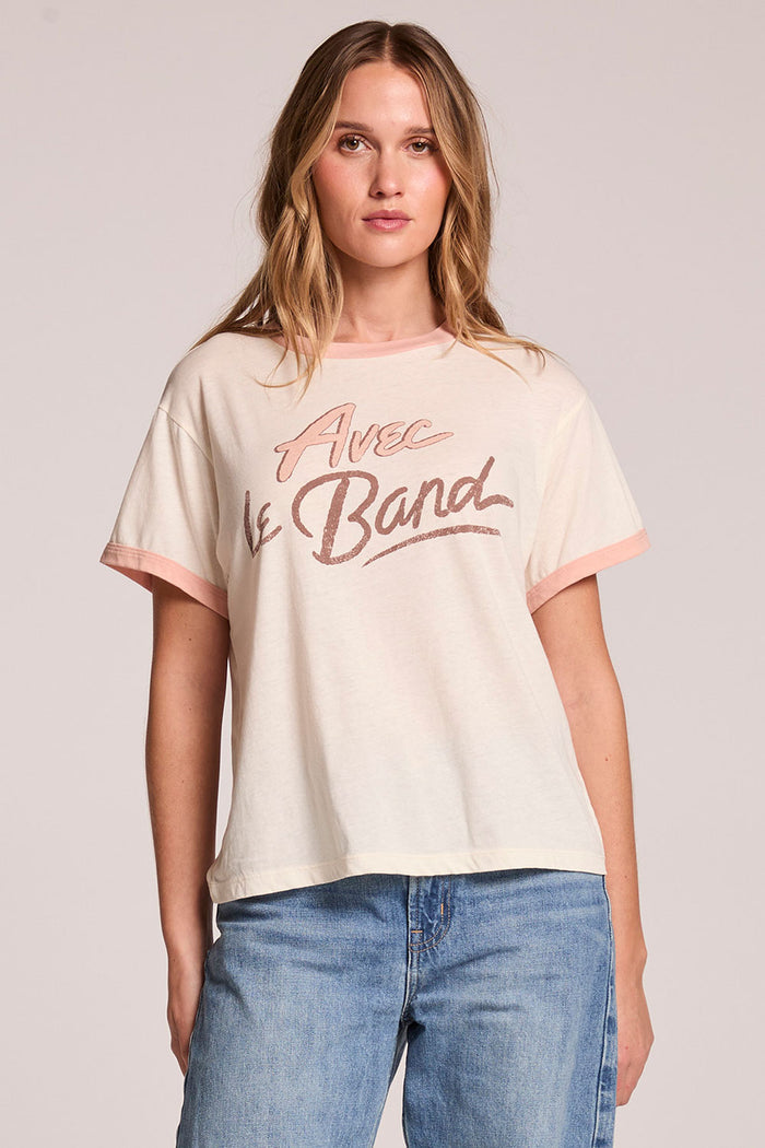 Front view of a woman wearing the Chaser  Avec Le Band Tee and jeans on a neutral background