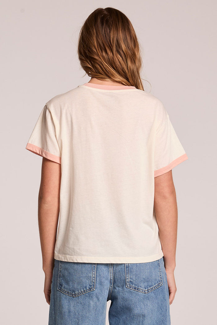 Back view of a woman wearing the Chaser  Avec Le Band Tee on a neutral background
