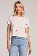 Front view of a woman wearing the Chaser Baby Heart Toss Tee and jeans on a neutral background