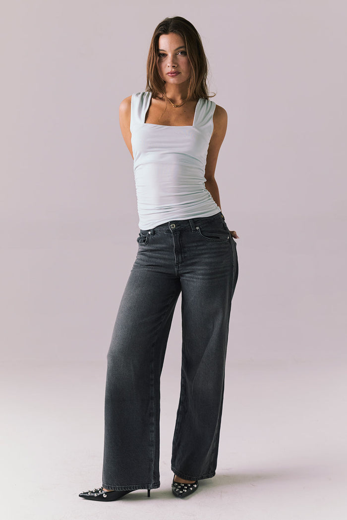 Woman wearing the Chaser Ballad Blue Sweetheart Tank styled casually with denim for a laid-back look