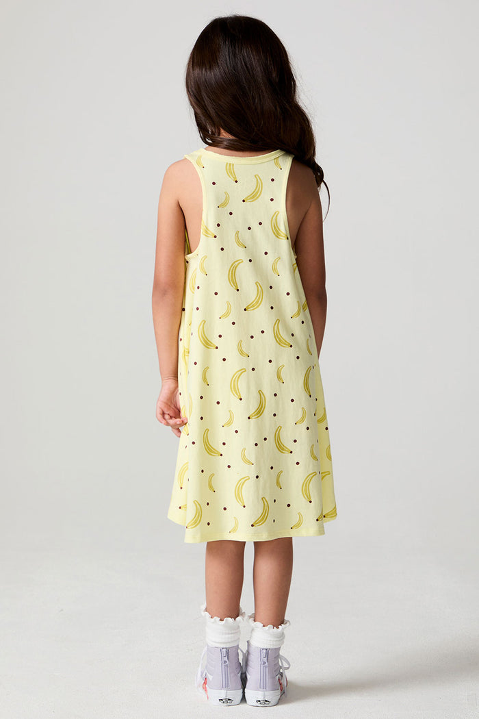 Full body back view of a girl wearing the Chaser Banana Babe Dress on a neutral background