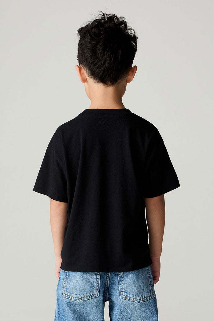 Back view of a boy wearing the Chaser  Basketball Boys Tee on a neutral background and jeans