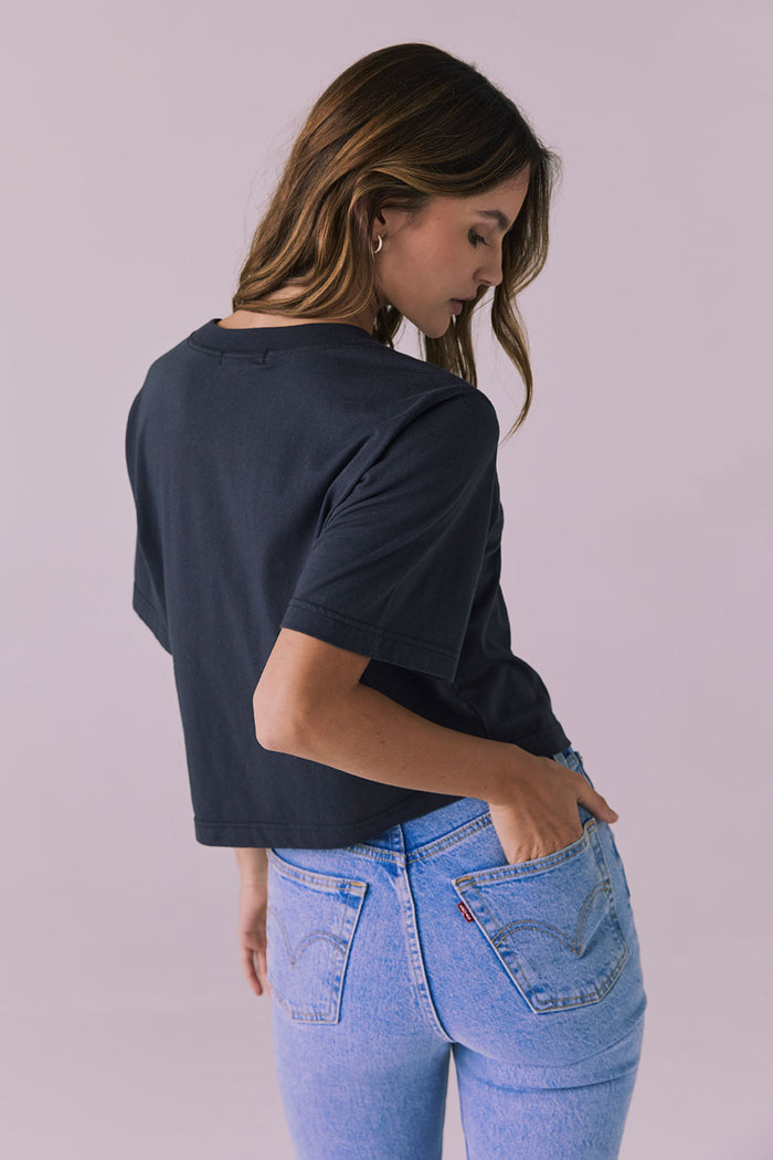 Back view of the Chaser Beau Licorice Black Tee highlighting the straight hem and smooth cotton texture