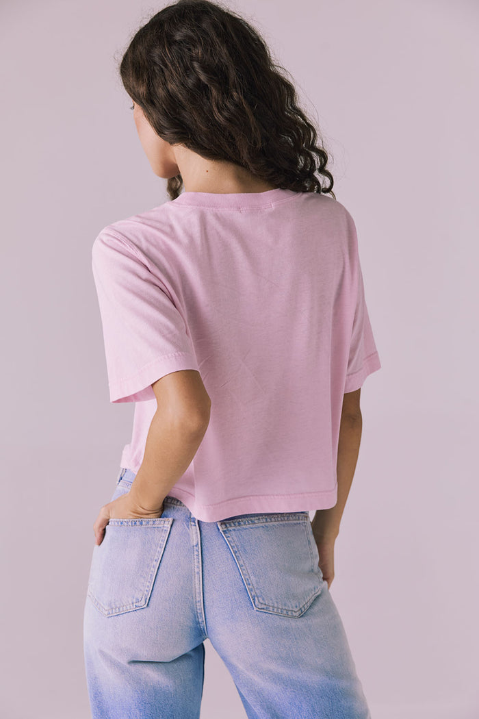 Back view of the Chaser Beau Nose Pink Tee highlighting the straight hem and smooth pastel finish