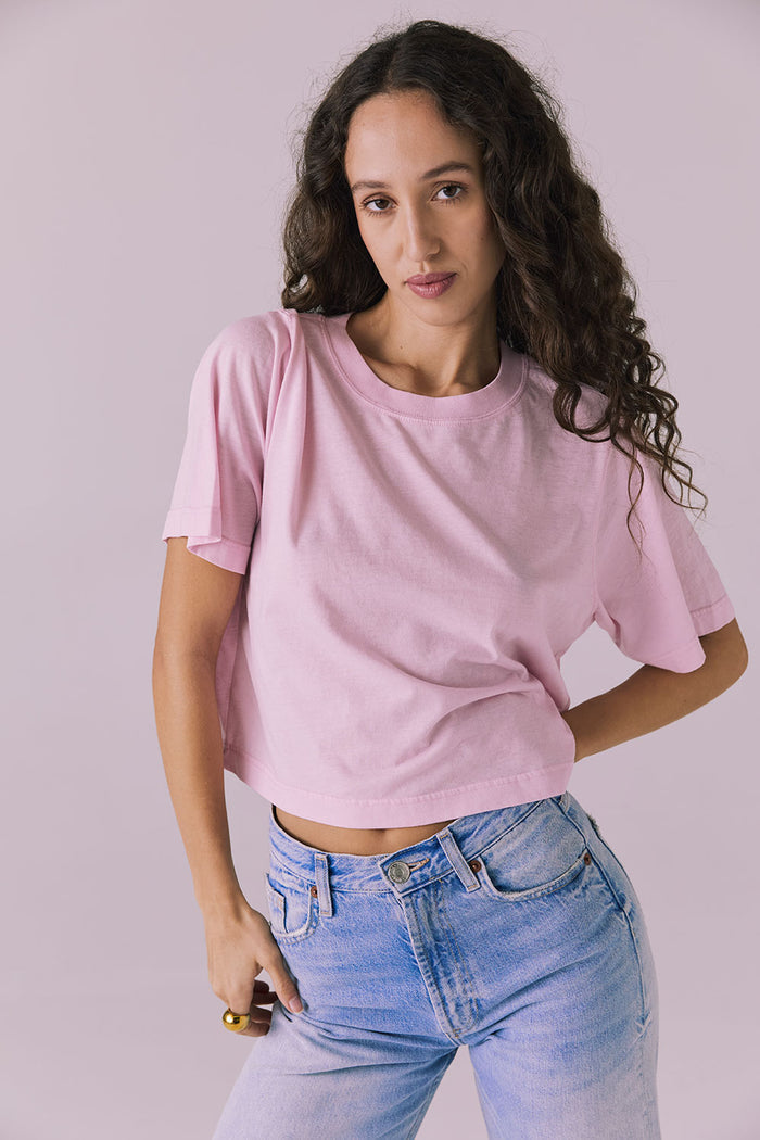 Woman wearing the Chaser Beau Nose Pink Tee featuring a boxy cropped silhouette and soft cotton texture
