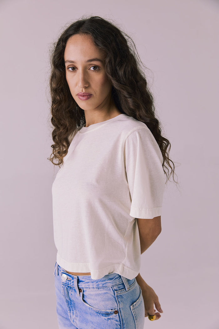 Side view of the Chaser Beau Starry White Tee showing the soft drape and relaxed short sleeves