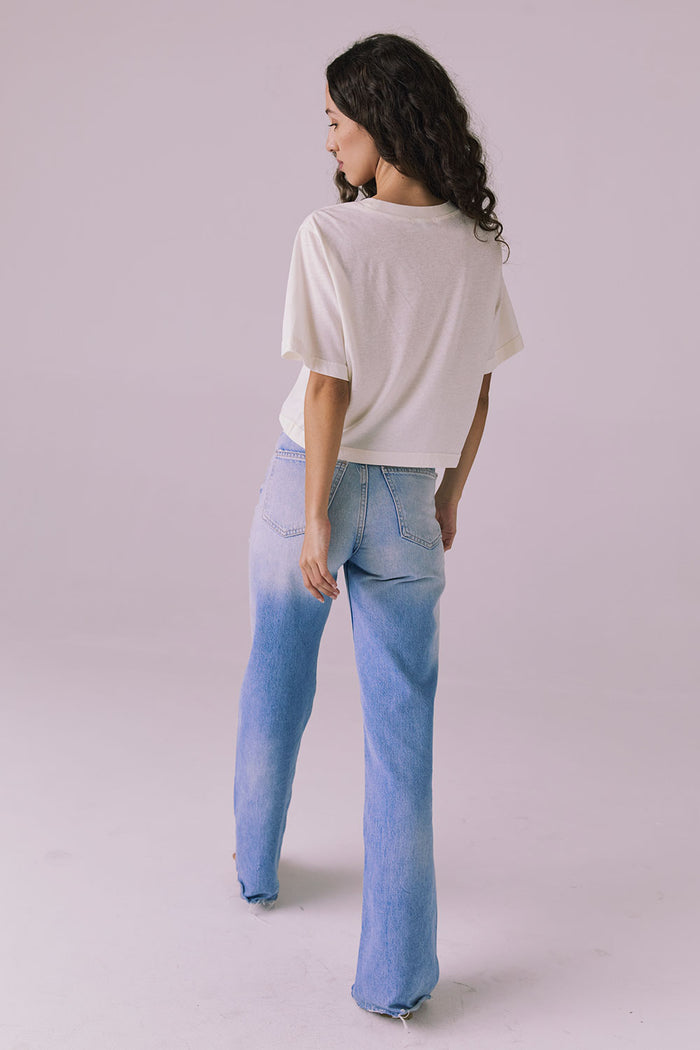 Back view of woman wearing the Chaser Beau Starry White Tee styled with denim for a timeless, easygoing look