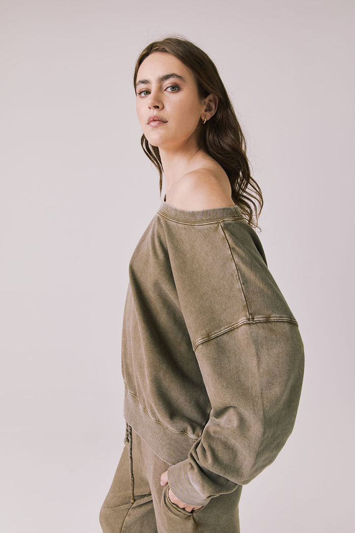 Side view of a woman wearing Chaser's Bellini Ginger Brown Pullover and matching pants on a white background