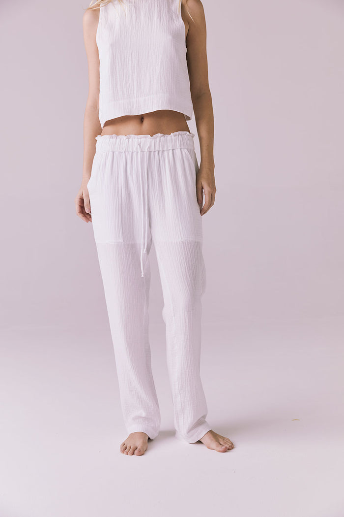 Model wearing the Chaser Bellow White Joggers featuring a relaxed fit and lightweight crinkle cotton texture