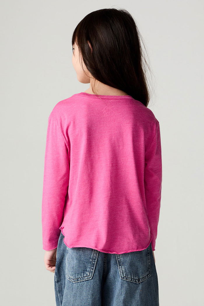 Back view of a girl wearing the Chaser Best Sister Girls Tee on a neutral background and jeans