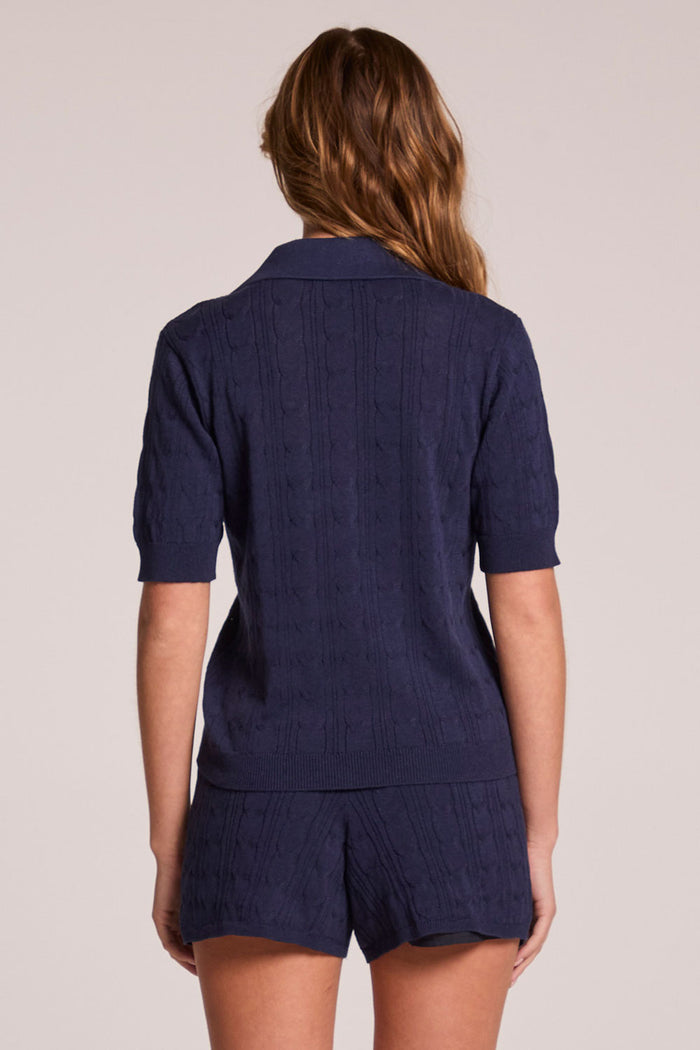 Back view of a woman wearing the Chaser  Bijou Admiral Polo  on a neutral background