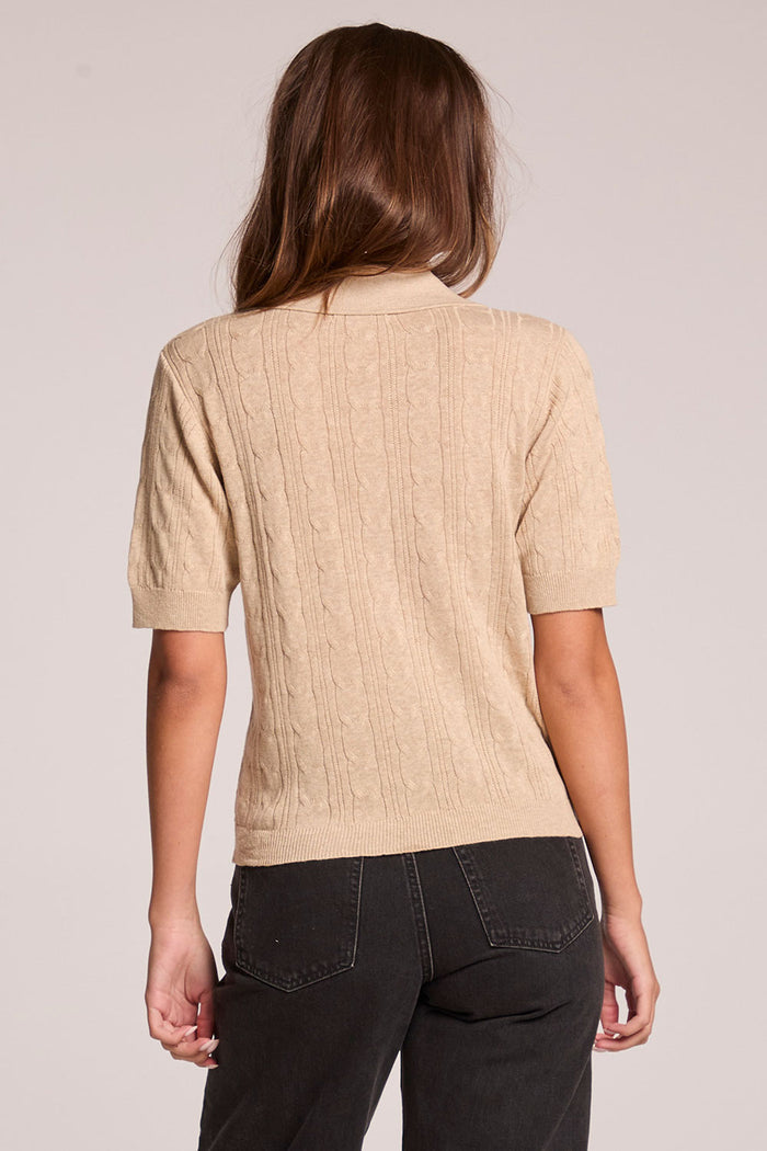 A back view of a woman wearing the Chaser Bijou Khaki Polo on a neutral background